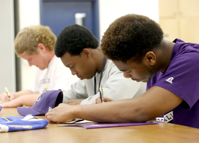 Cove footballers sign with colleges